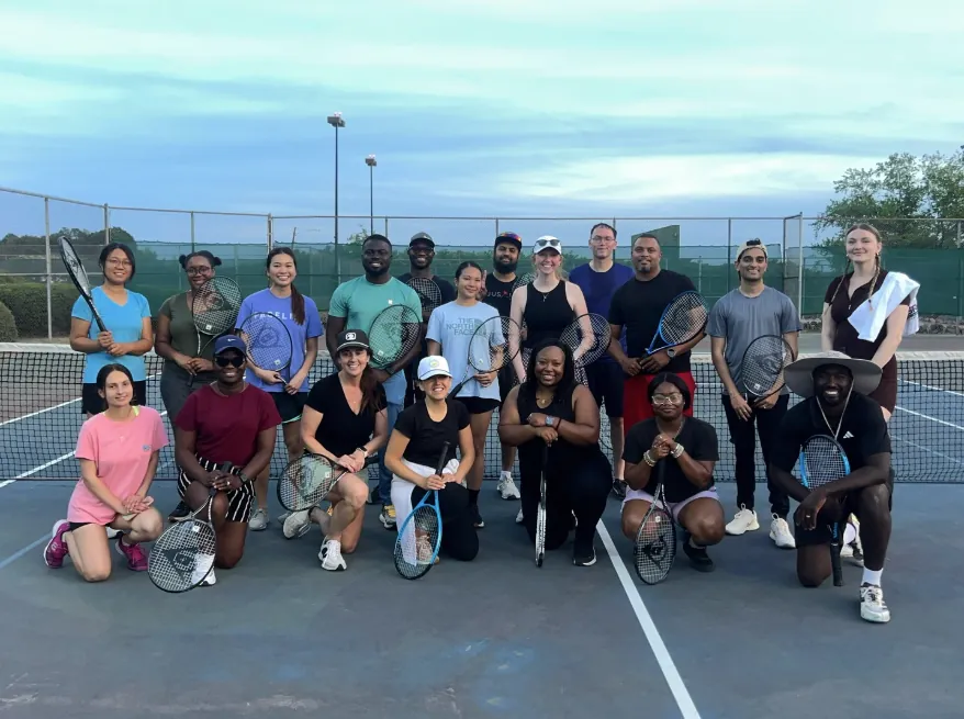 J15 Tennis Academy group on court at dusk